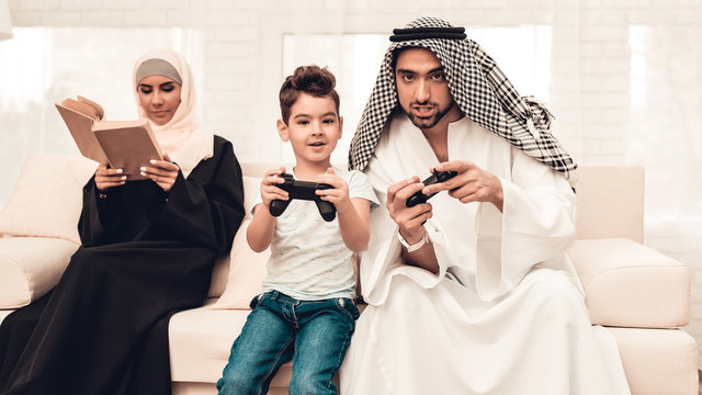 Happy Arabian Family Playing on Console at Home.