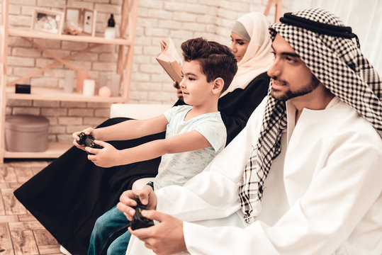 Happy Arabian Family Playing on Console at Home.