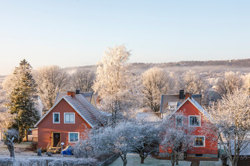 Detached house with frost on trees