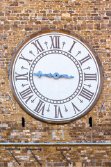 Old clock on a house wall
