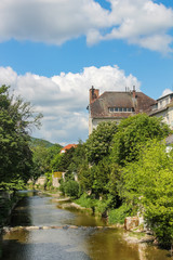 Fototapeta na wymiar houses and trees on the banks of the Muhlbach stream in Baden. Austria