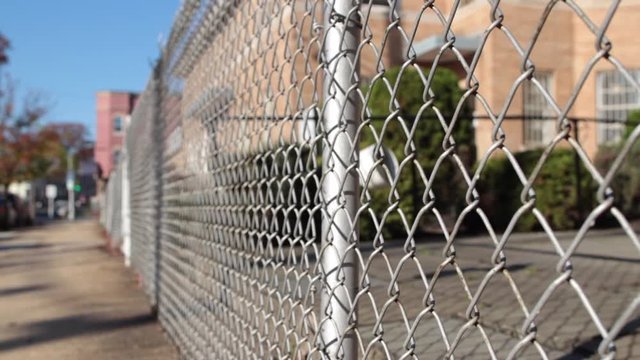 Chain link fence on angle and sidewalk