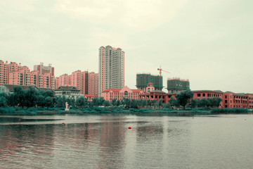 Naklejka premium unfinished buildings by the water side