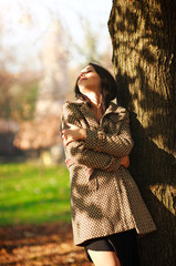 Dreamy girl enjoying the sun in spring park, freshness of nature and freedom concept