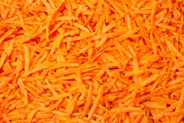 Many of juicy grated carrots. Food background.