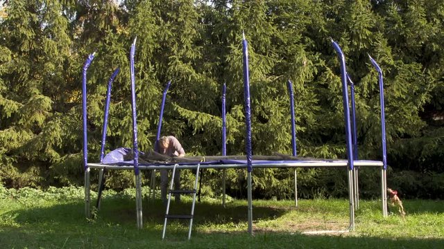 Disassembling take down  trampolina at backyrard. Stop motion