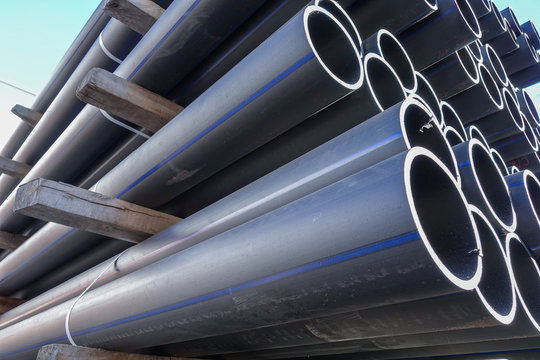 Plastic pipes in stock of finished products stacked in packs
