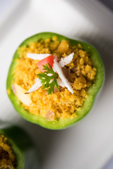 Stuffed capsicum or bharwa shimla mirchi is a popular Indian main course recipe. Served in a plate over moody background. Selective focus