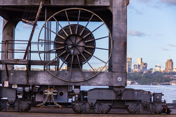 old rusted crane wheels city background