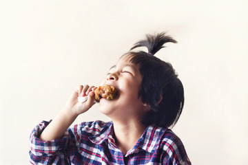 cute little asian boy eating fried chicken and laugh on vintage color background