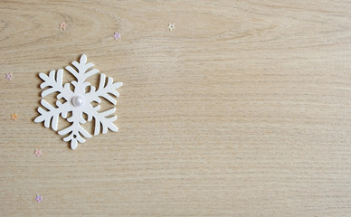 Fototapeta na wymiar snowflake on wooden background, christmas background