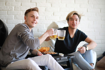 Football fans watch the match and drink beer