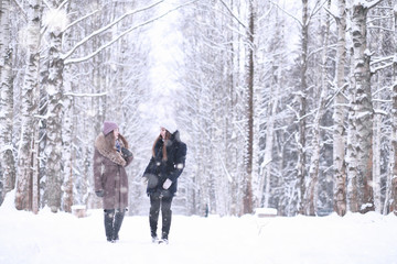 Girl in a winter park in snowfall