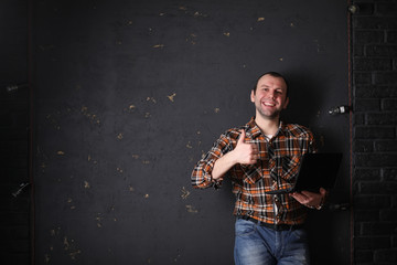 Male architect builder in a protective helmet