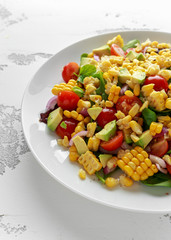 Sweet Corn salad with tomatoes, avocado, red onion, herbs and lime
