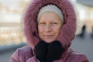 Portrait of a beautiful middle-aged woman outdoors. Selective focus.