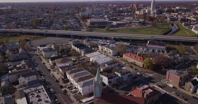 Drone parallax from city church to highway horizon