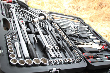 Fototapeta premium Suitcase repair tools for machinery and equipment. Hazelnuts, nozzles, hammer and more