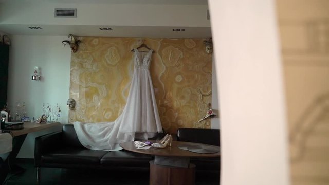 Wedding bridal dress at morning preparation in white bedroom