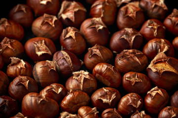 Roasted chestnuts served in cast iron vintage pan.