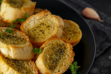 Fresh Garlic Bread, toast on black plate