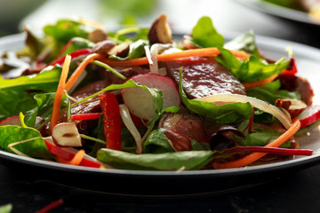 Spicy Beef Salad with Carrots, radish, bean sprouts, chilli, nuts and green mix