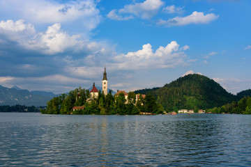 Iconic landscape view of beautiful St. Marys Church of Assumption on small island,lake Bled in...