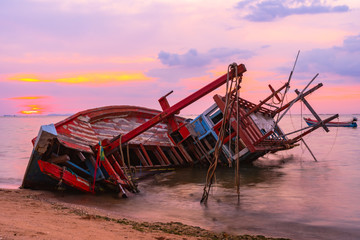 Old fishing boat shipwrecks disposed on the beaches of the eastern coast of Thailand, view and...