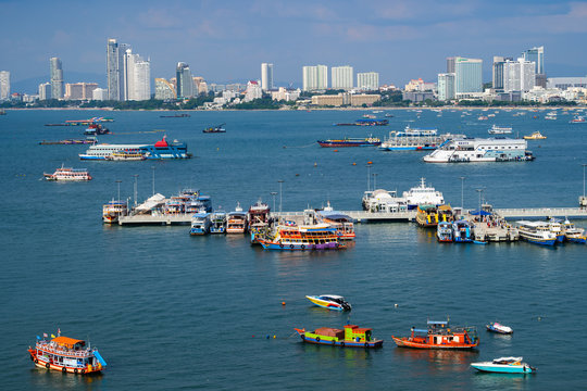 The view of the scenery is filled with the beauty of the sea, the sky and many ships that park in the bay and the city.