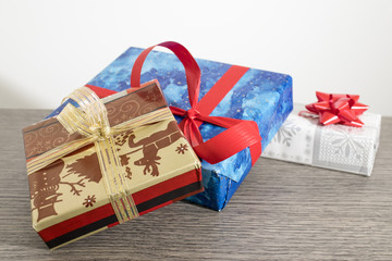 Christmas gifts with colored papers on a wood table