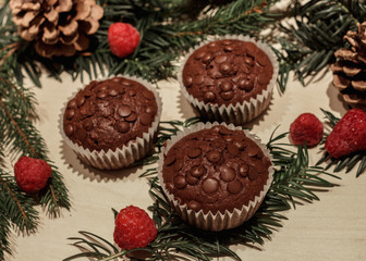 Three chocolate chip cupcakes and some raspberries