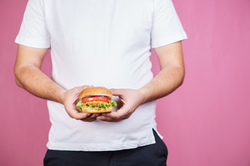 glutton man eating tasty burger. imbalanced ration, snacking with fast food, unhealthy diet