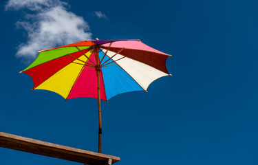 Colorful umbrella with blue sky.