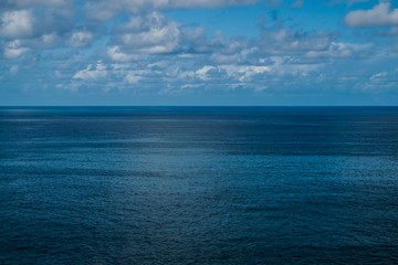 Altantic ocean seascape, with blue sky and white clouds background