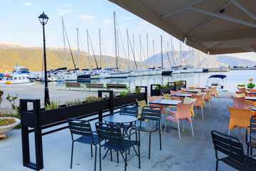 Empty greek cafe on seaside background overlooking Ionian sea, Sami, Kefalonia, Greece
