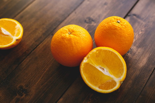 Juicy bright oranges on a wooden table