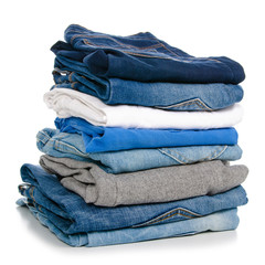 A stack of clothes jeans pants on a white background. Isolation