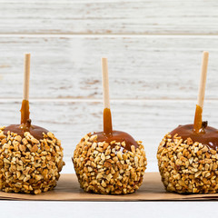 Caramel Apples on Wooden Background. Selective focus.