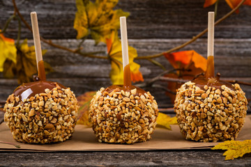 Caramel Apples on Wooden Background. Selective focus.