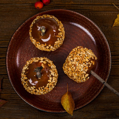 Caramel Apples on Wooden Background. Selective focus.