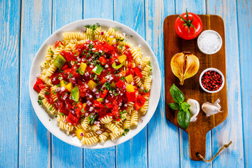 Pasta with vegetables on wooden background
