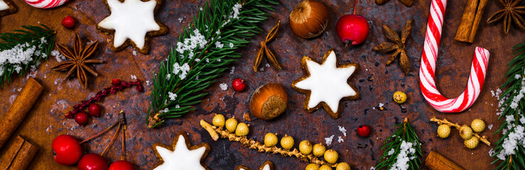 Christmas Background with Star Gingerbread Cookies and Holiday Decorations on Old Rusty Background. Selective focus.