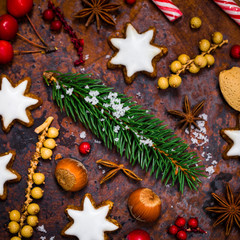 Christmas Background with Star Gingerbread Cookies and Holiday Decorations on Old Rusty Background. Selective focus.