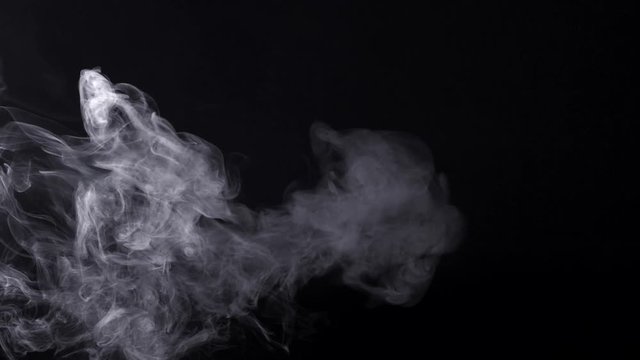 Smoke over balck background. Slow motion.