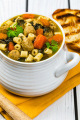 Soup with Meatballs, Carrots and Spinach in Chicken Broth. Selective focus. 