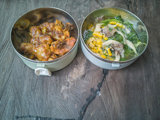 Selective focus the delicious meal consists of Chicken Oyster Sauce and Vegetable Soup on the top of wooden table.