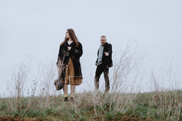 Atmospheric Portrait of a girl with a guy on the subject: parting, racking up, depression, longing, fear, loss, past in the field. Psychological portrait of the end of the relationship