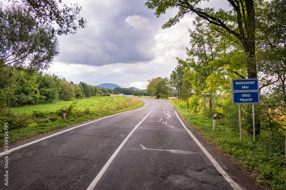 Wall mural Road sign marks border of Bratiislava region and Malacky district in Slovakia - Wall murals