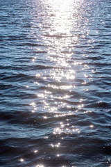 Background shot of sea water surface. glare of the sun on the surface of the water.