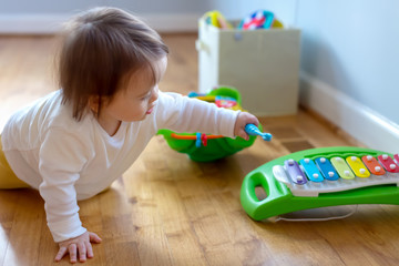 Toddler boy playing with a musical instrument